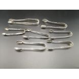 Seven pairs of silver sugar tongs