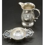 Silver tea strainer and milk jug