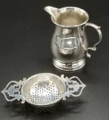 Silver tea strainer and milk jug