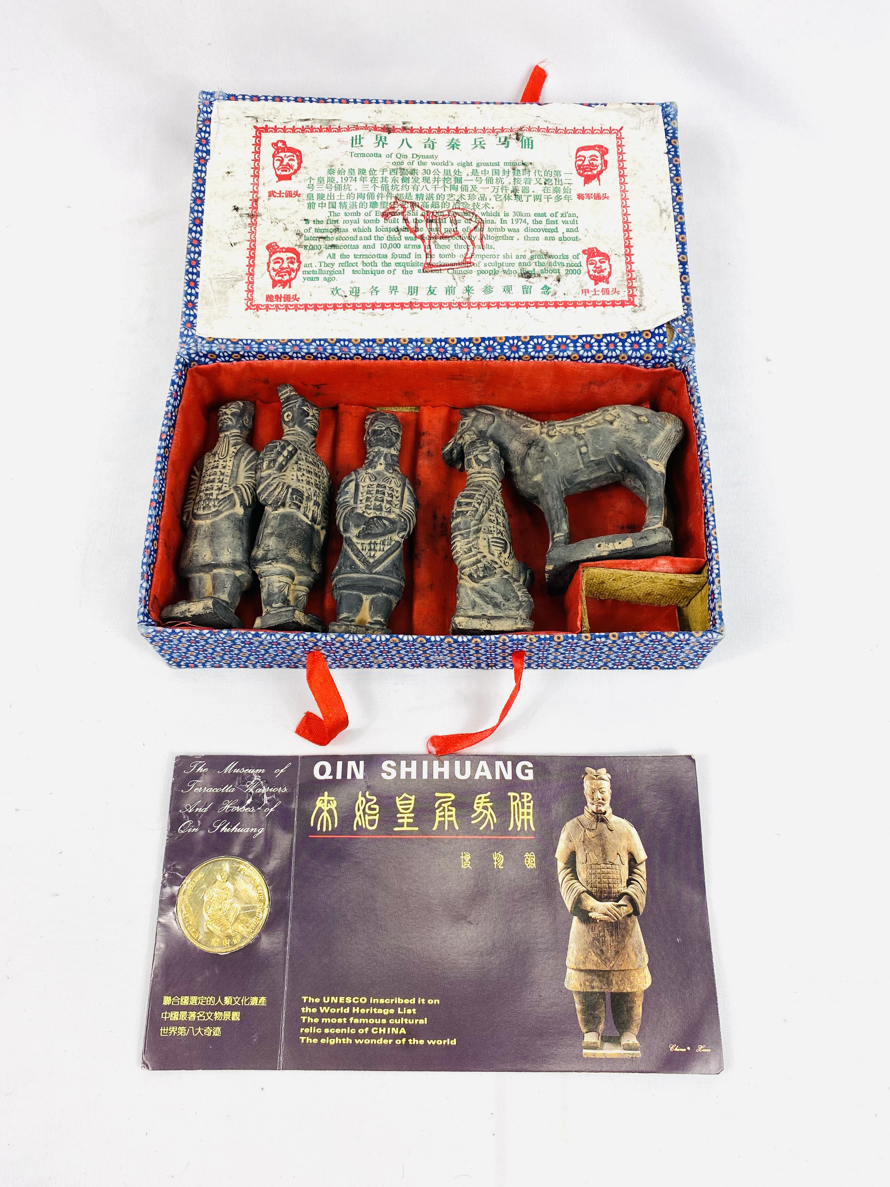 Set of five models of the terracotta army together with a commemorative coin