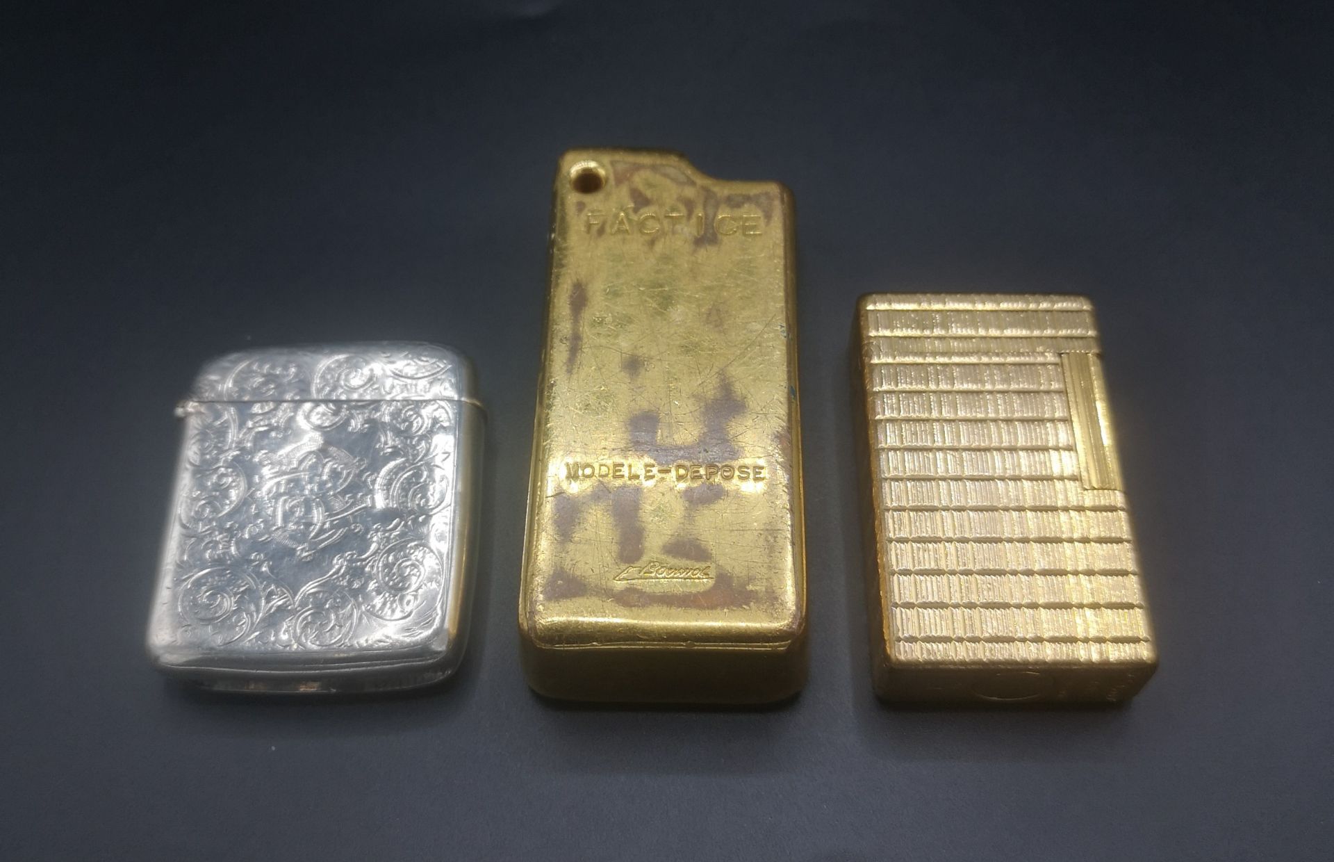 Silver vesta case, Dupont lighter and a gold coloured lighter case