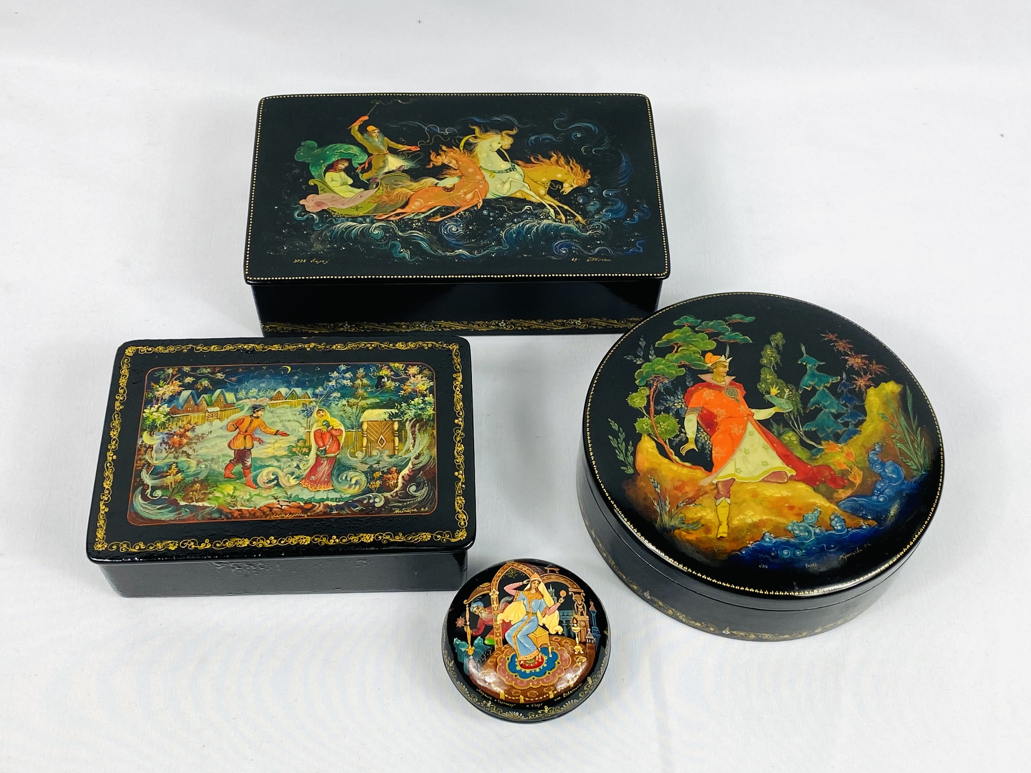 Four black lacquer boxes