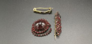 Two Victorian yellow metal brooches set with garnets
