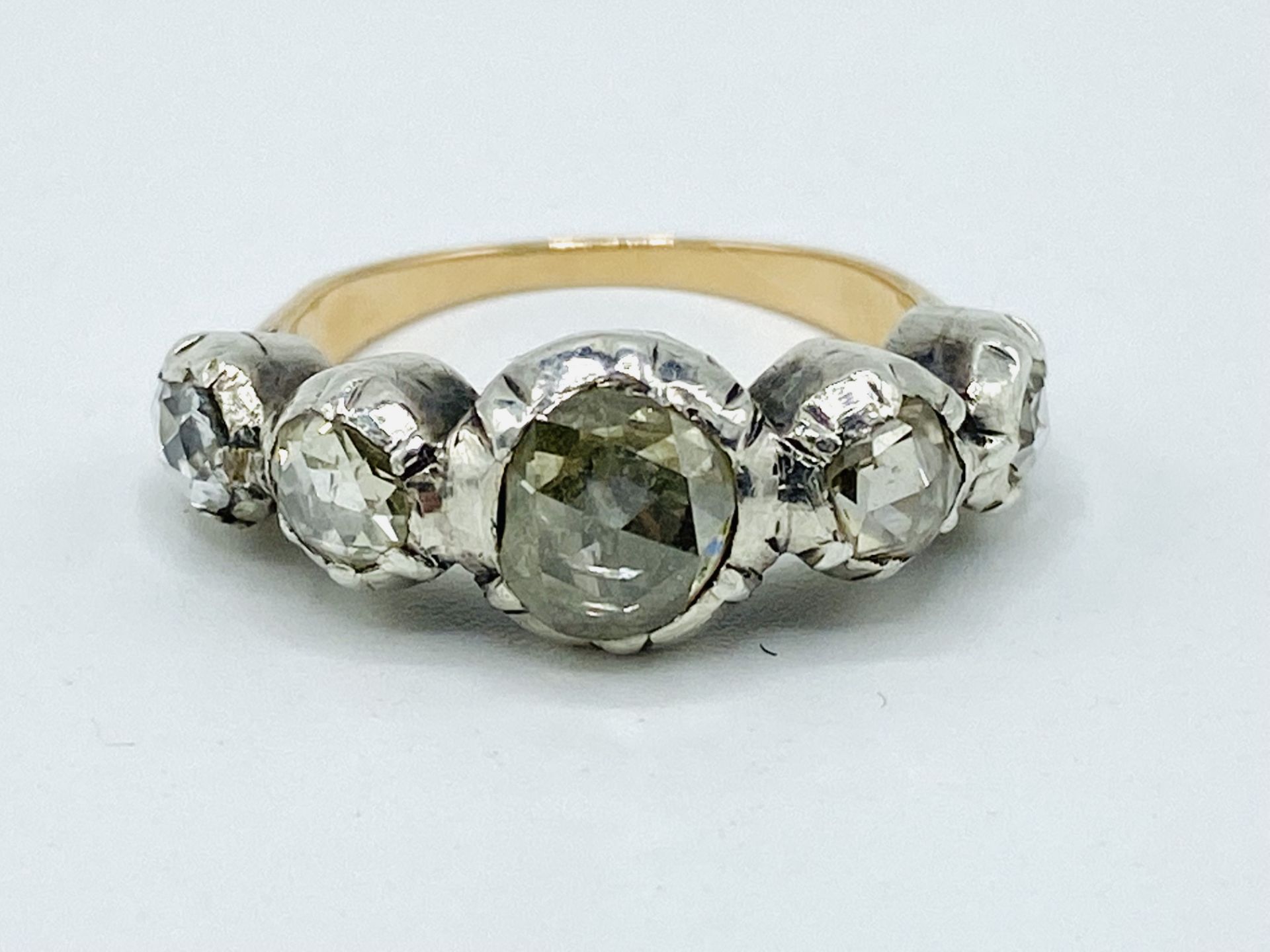 Yellow and white metal ring set with five rose cut diamonds