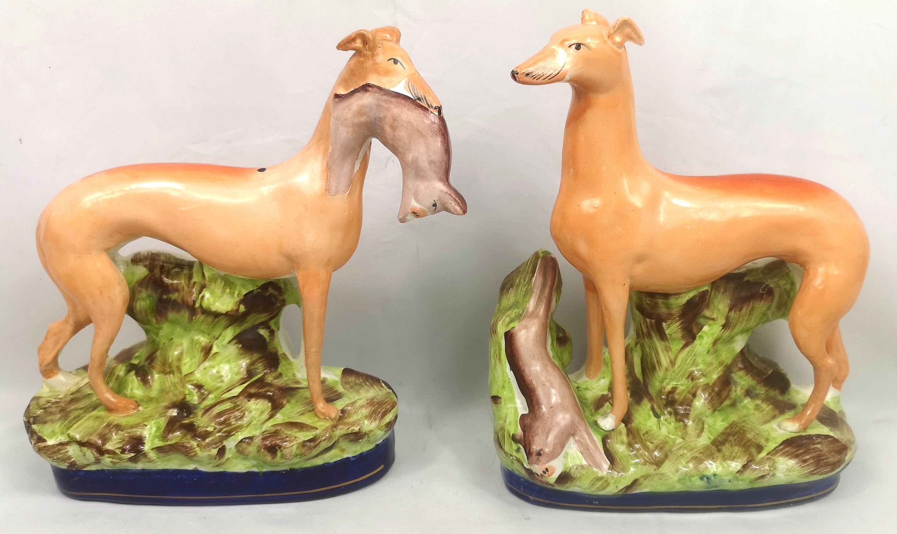 Two Victorian Staffordshire hand painted hunting dogs