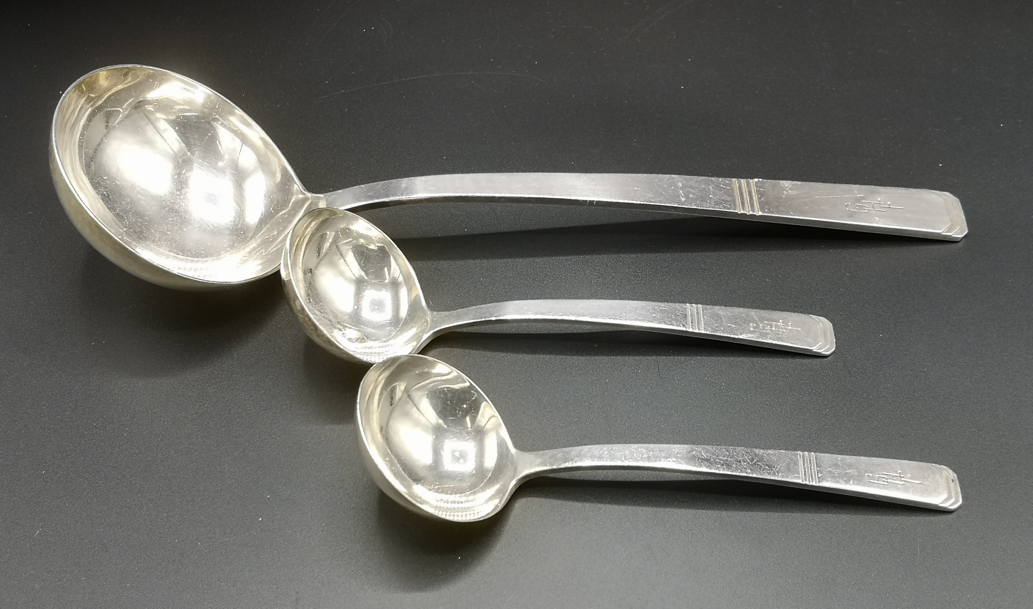 Silver ladle together with a matching pair of small ladles