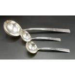 Silver ladle together with a matching pair of small ladles