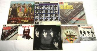 Four Beatles EP's together with four Beatles LP's
