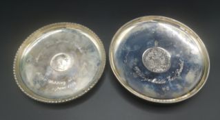 Two silver dishes with coins to centre