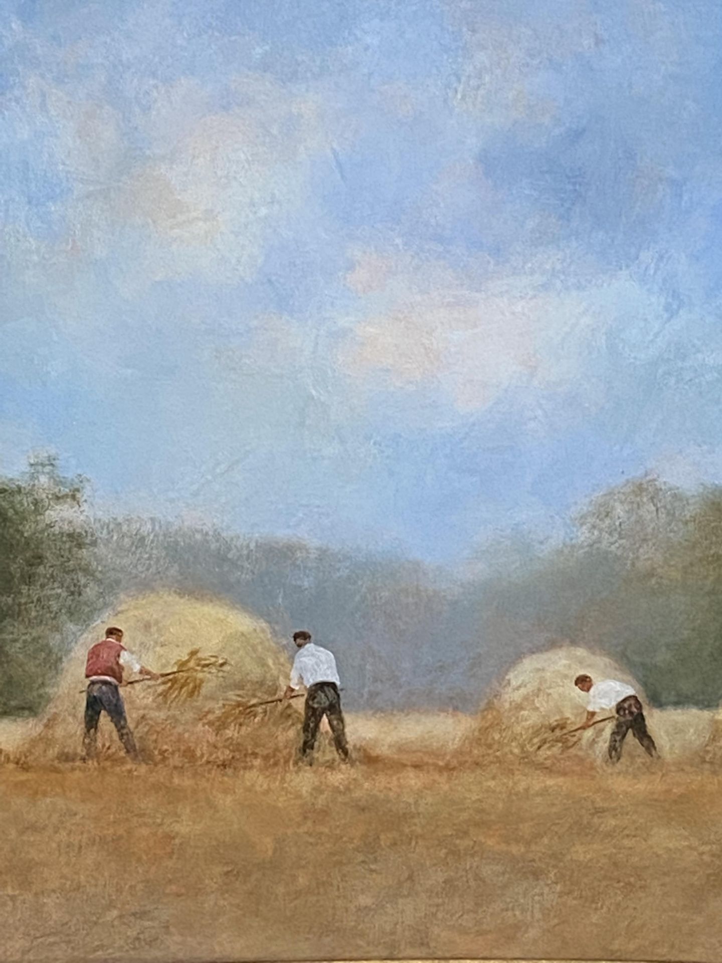 Framed and glazed watercolour of three men making haystacks