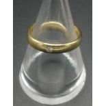 18ct gold band set with a diamond chip