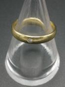 18ct gold band set with a diamond chip