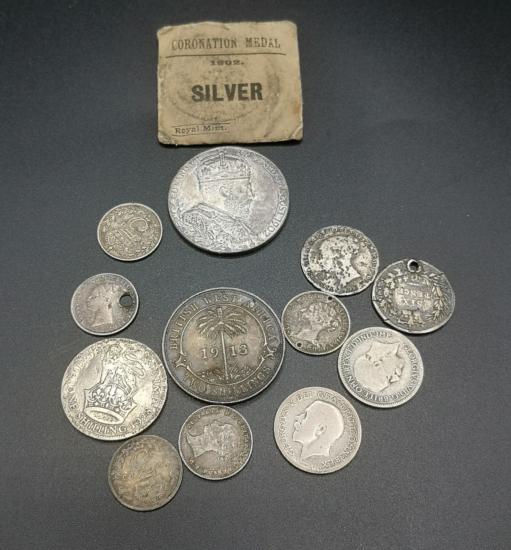 A collection of Victorian, Edwardian, and Georgian silver coins and a medal