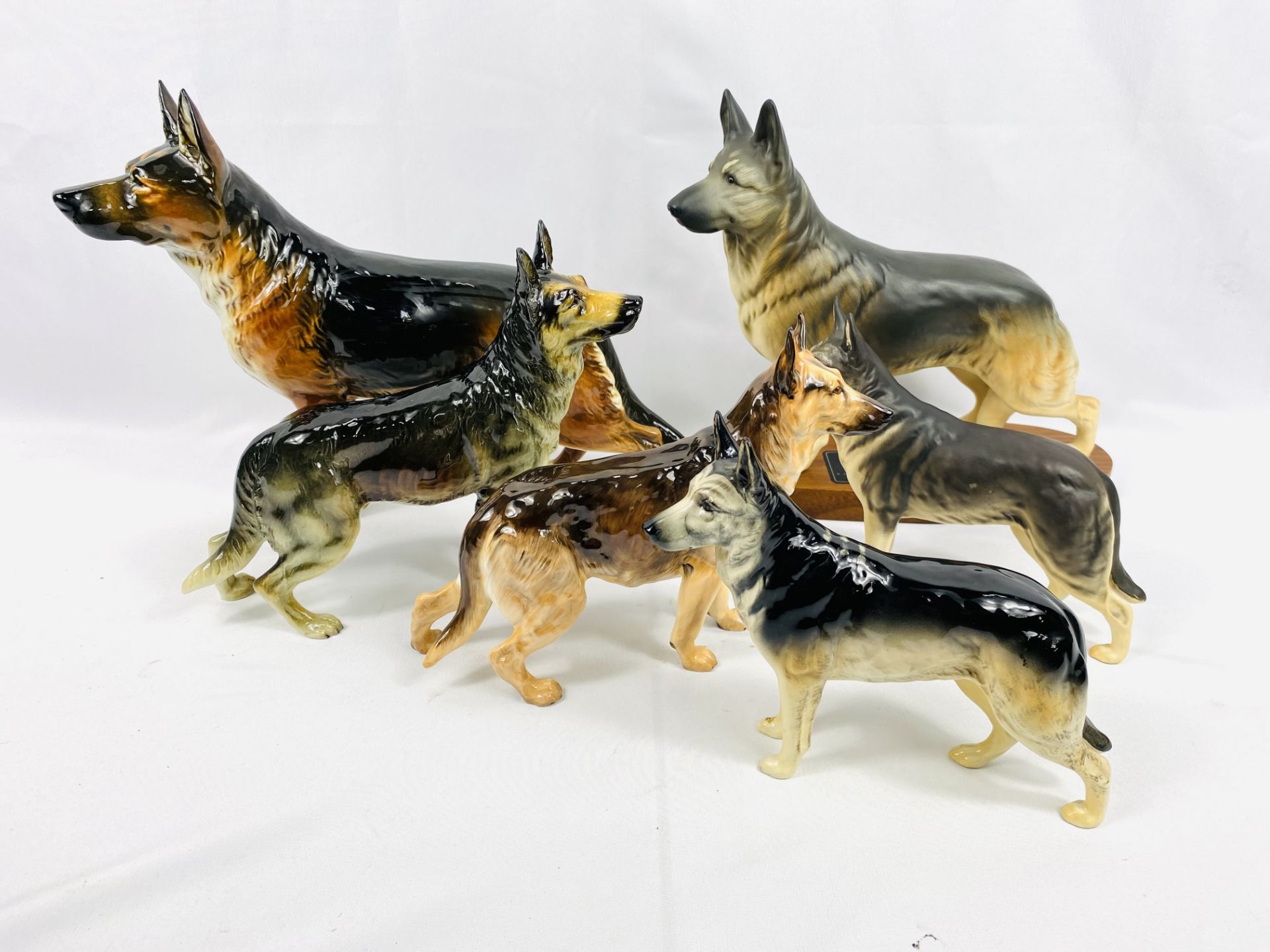 A Beswick Alsatian together with four other ceramic alsatians