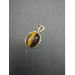9ct gold pendant set with a tiger's eye