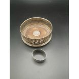 Silver bottle coaster together with a silver napkin ring