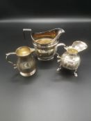 Two Georgian silver jugs together with a Victorian silver jug