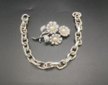 Silver necklace together with a silver brooch