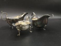 A georgian silver sauce boat, a silver sauce boat and a silver plate sauce boat