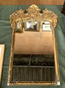 Gilt framed mirror with carved pediment.