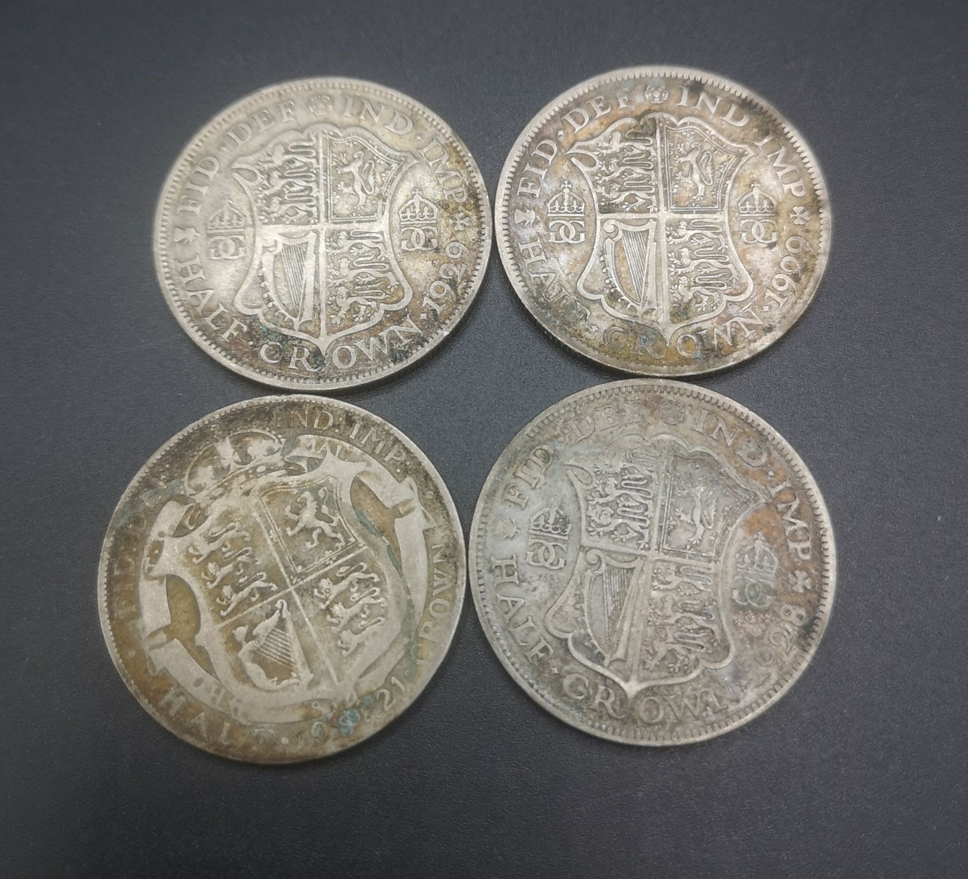 Four King George V half crowns