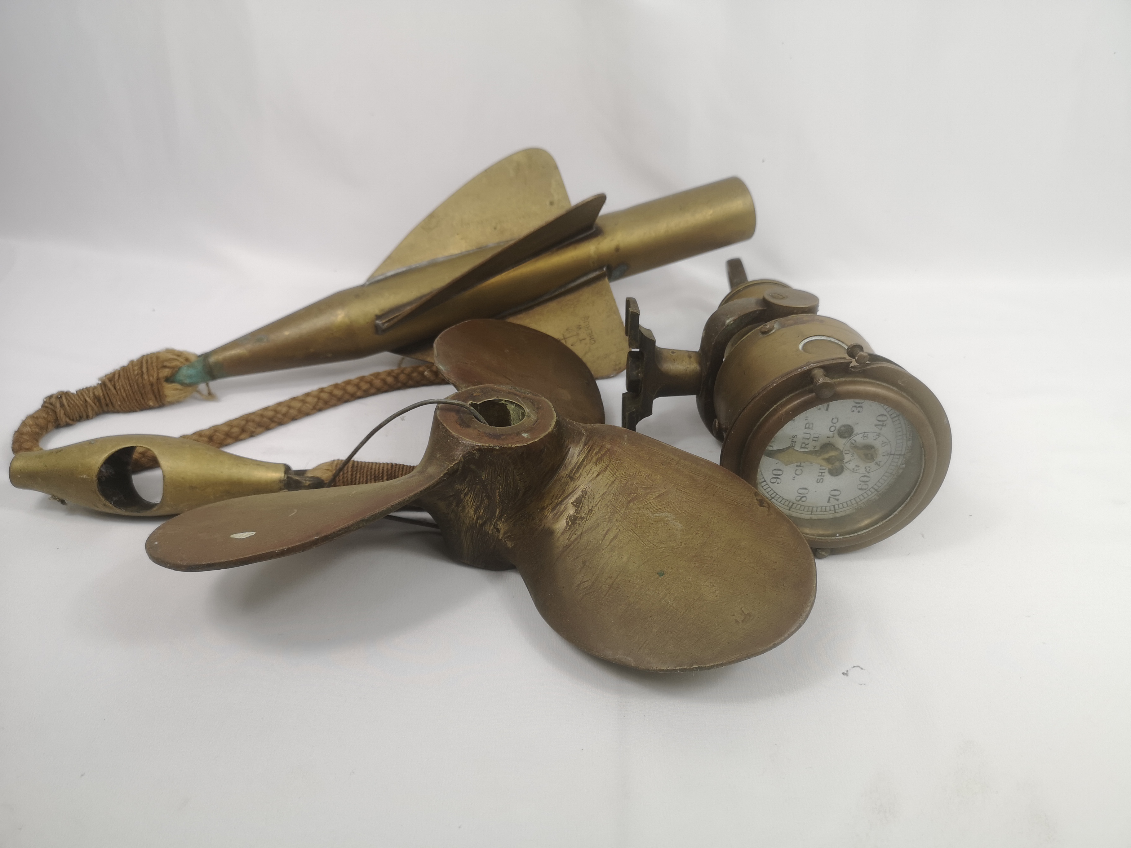 Cherub brass ships log dial and rotator; together with a propellor