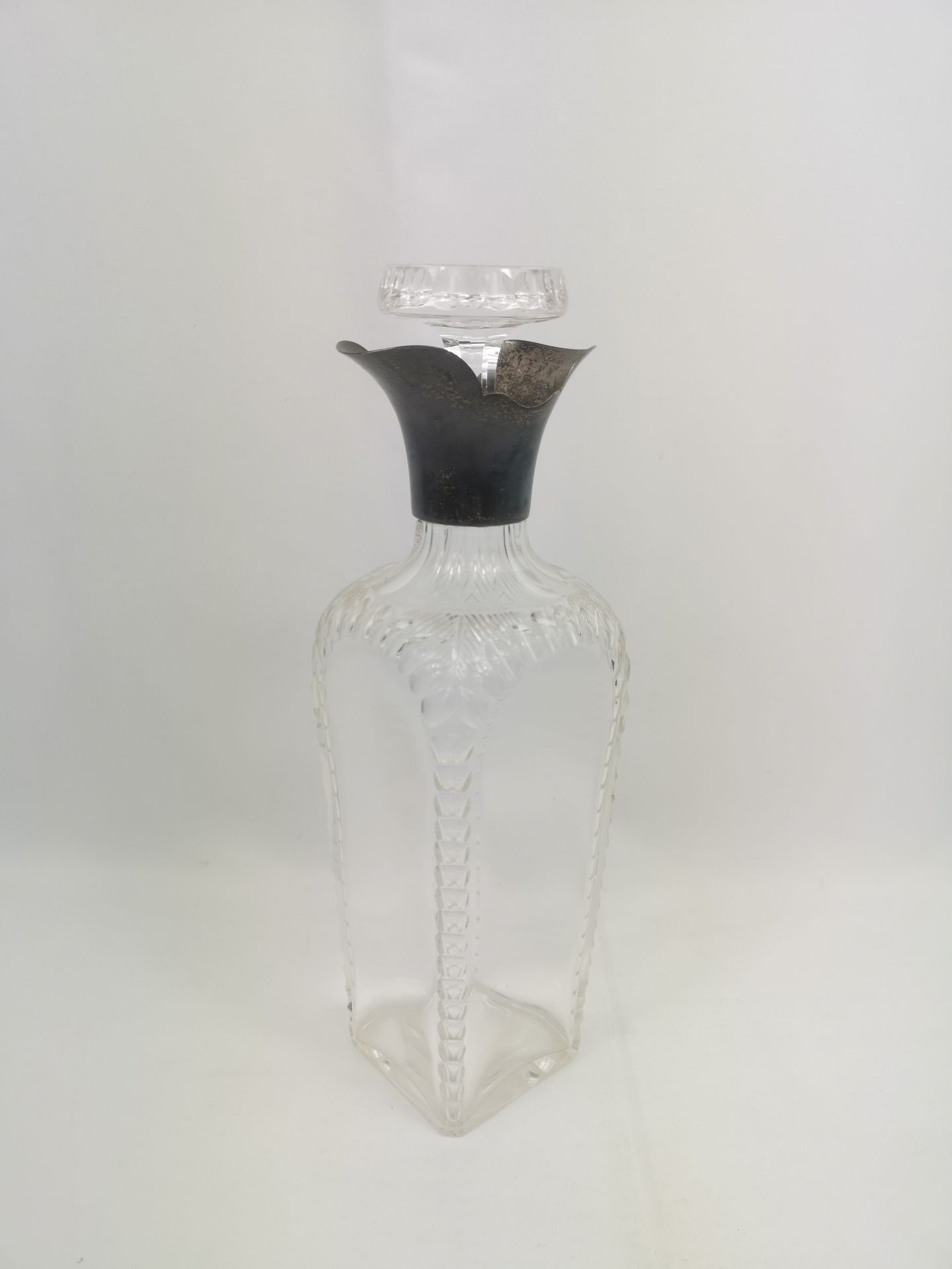 Cut glass decanter with silver collar