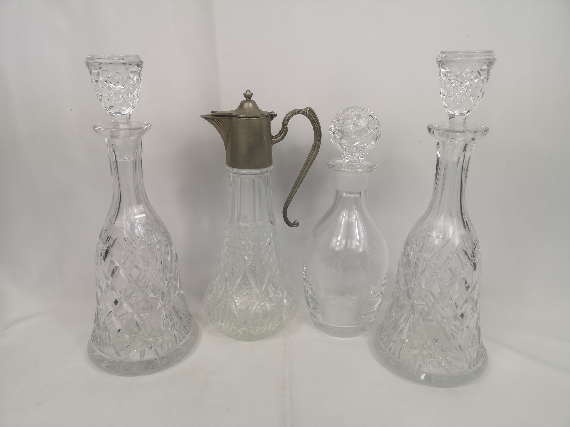 Three glass decanters and a claret jug