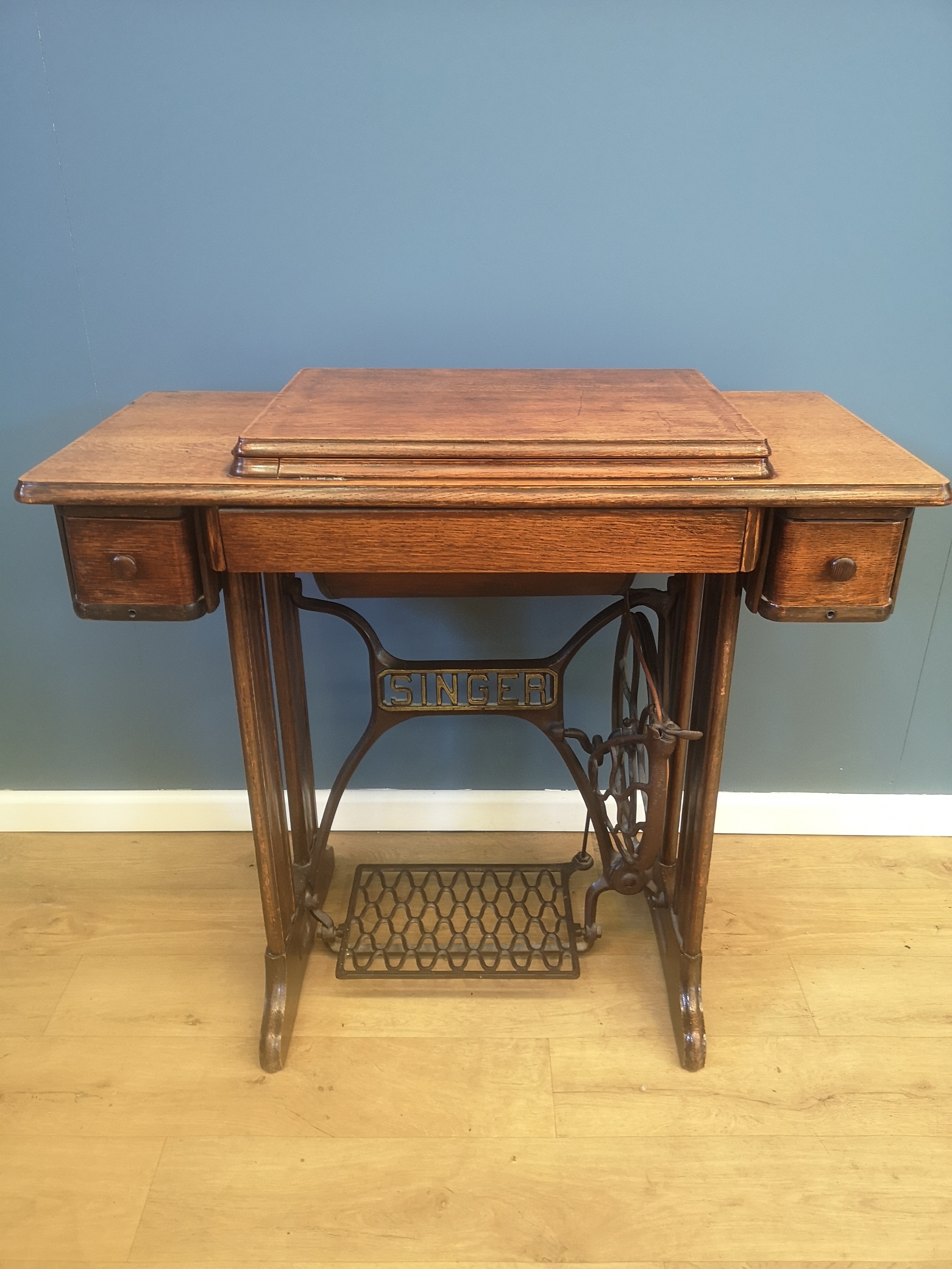 Singer sewing machine set in an oak treadle table