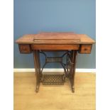 Singer sewing machine set in an oak treadle table