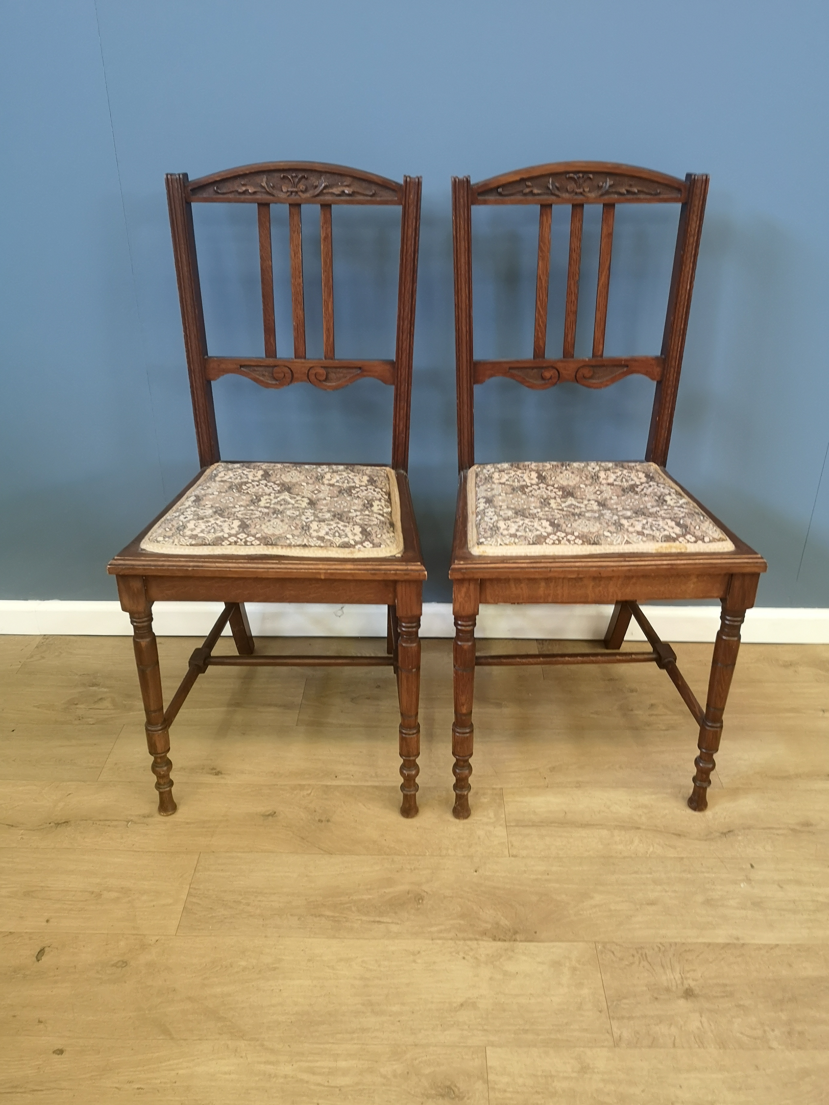 Two oak rail back dining chairs