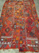 Hand made red ground rug