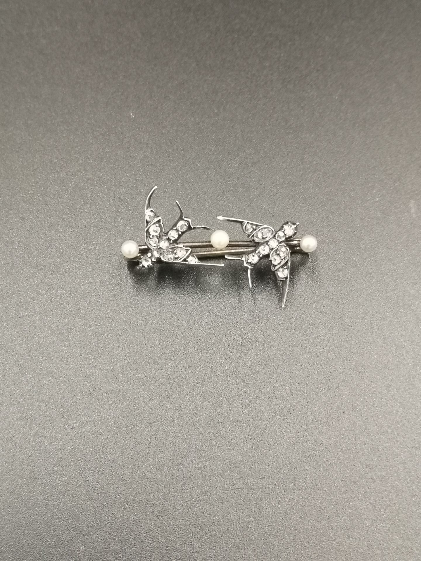 White metal brooch set with diamonds