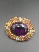 Brooch set with amethyst, diamonds and rubies