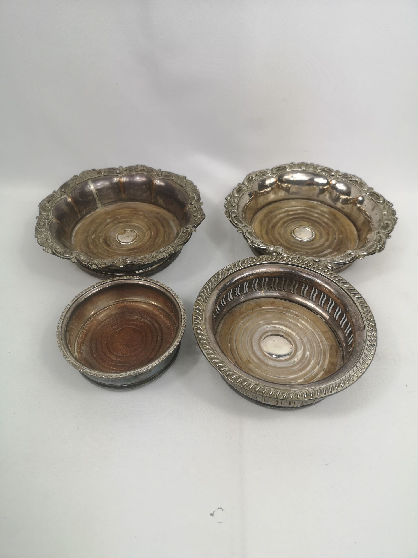 Pair of Sheffield plate bottle coasters together with a silver plate coaster