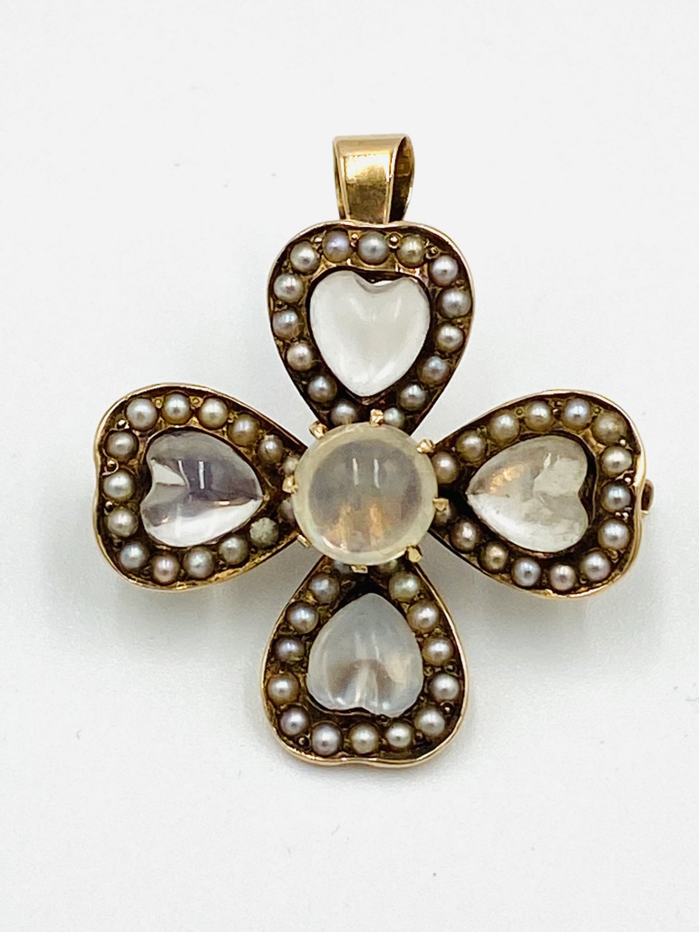 Gold flower pendant set with moonstone