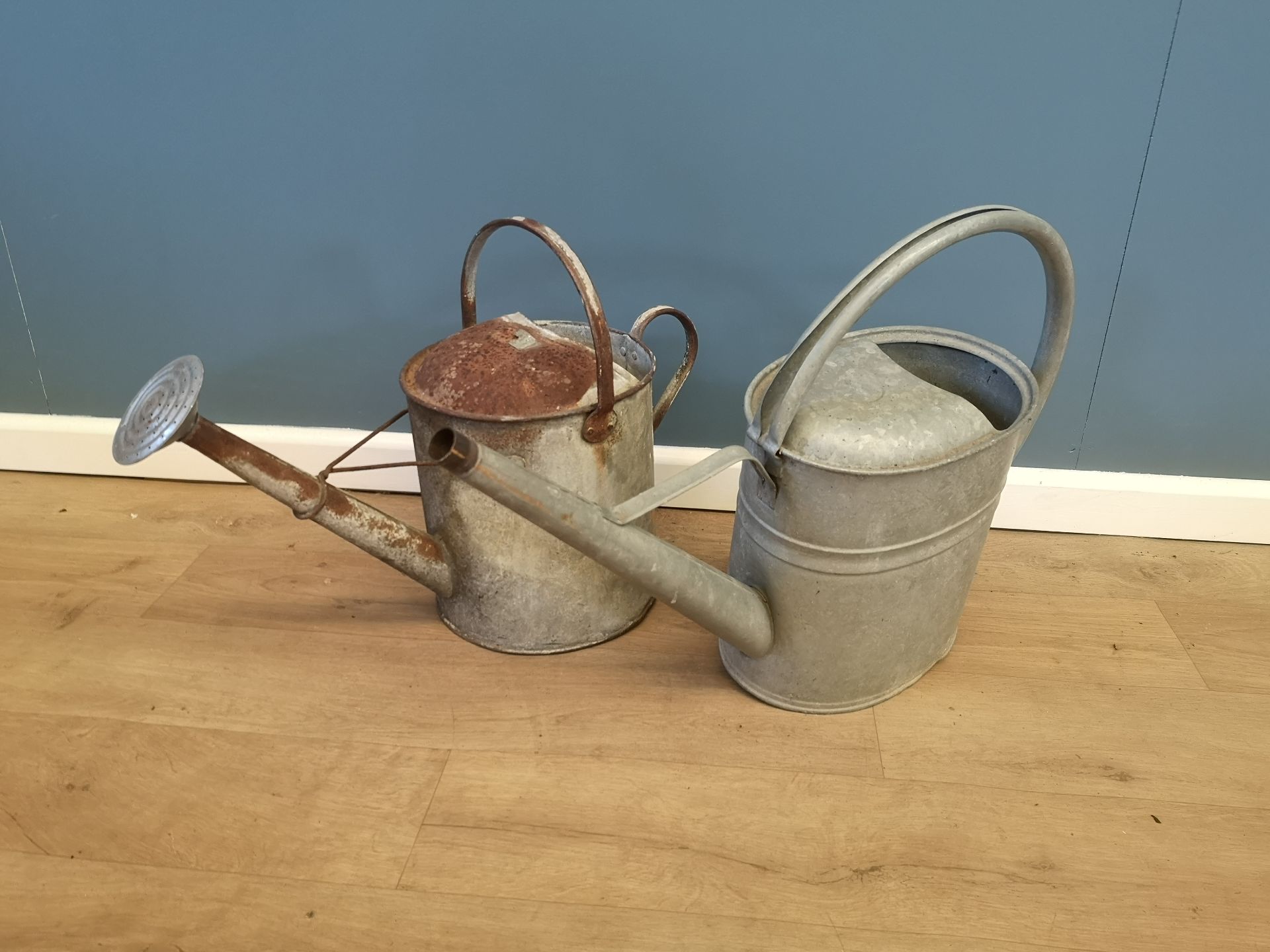 Two galvanised watering cans