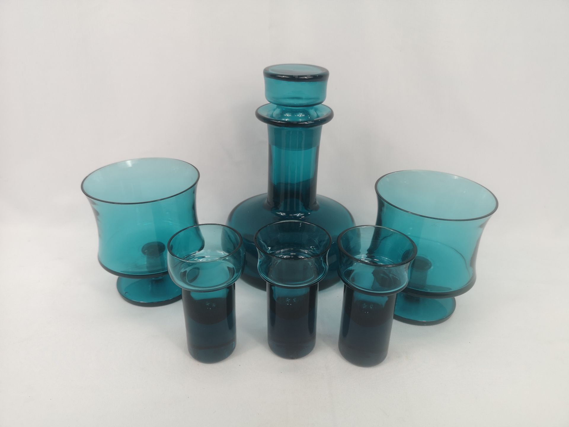 Blue glass decanter together with blue glasses