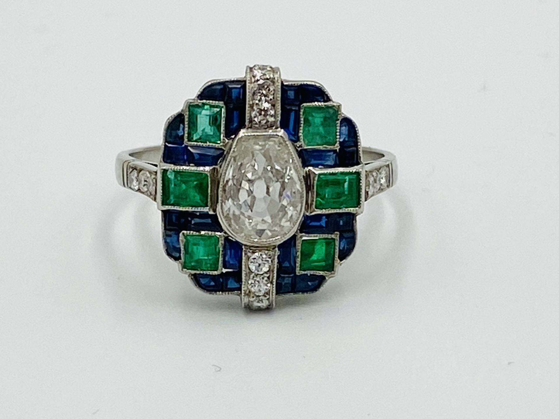 Platinum ring set with diamonds, sapphires and emeralds