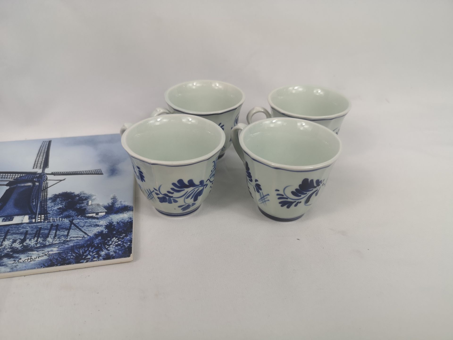 Four Delft cups and saucers together with a Delft tile - Image 2 of 4
