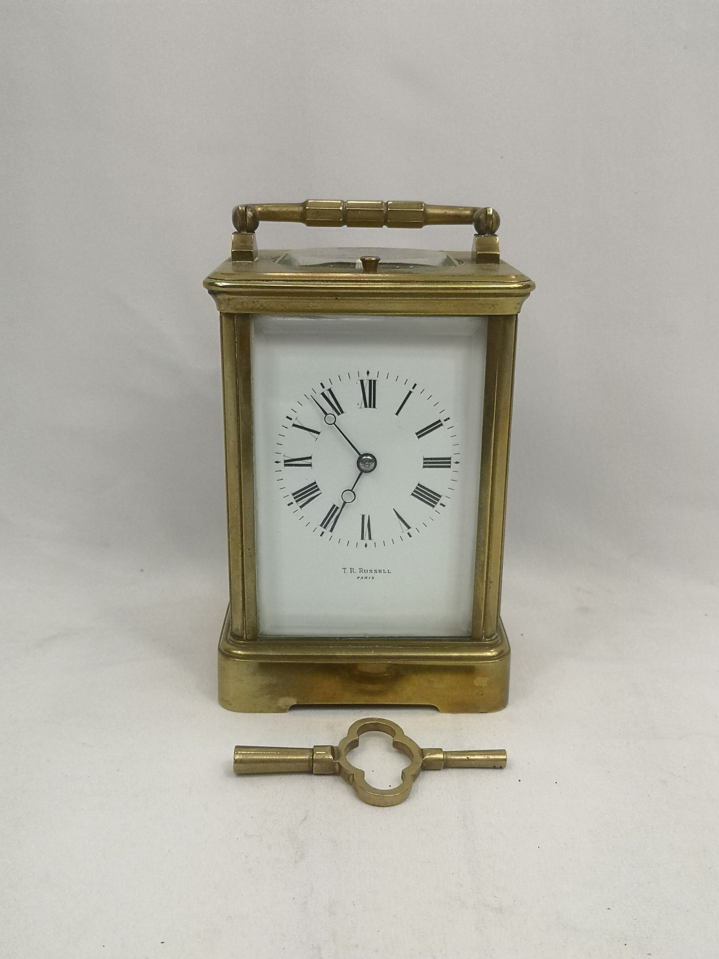 Brass carriage clock written to face T.R. Russell
