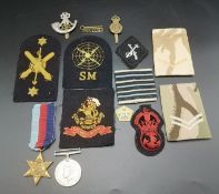 Two WWII medals together with a quantity of military patches and badges