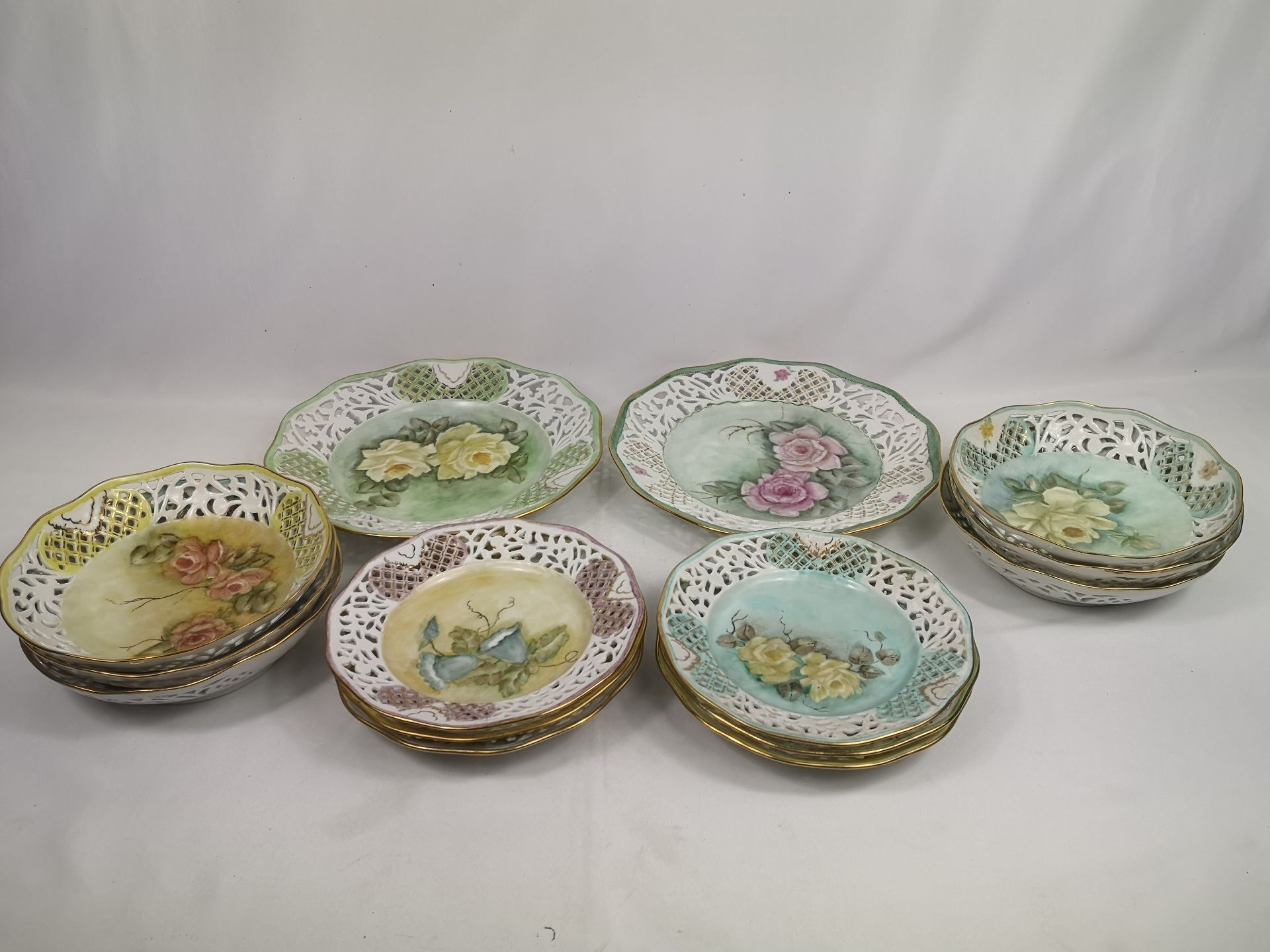 Quantity of hand painted plates and bowls by Marjorie Stevenson