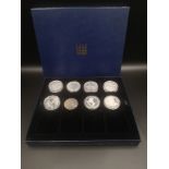 Siz silver proof £5 coins together with two silver 10 franc coins