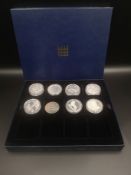 Siz silver proof £5 coins together with two silver 10 franc coins