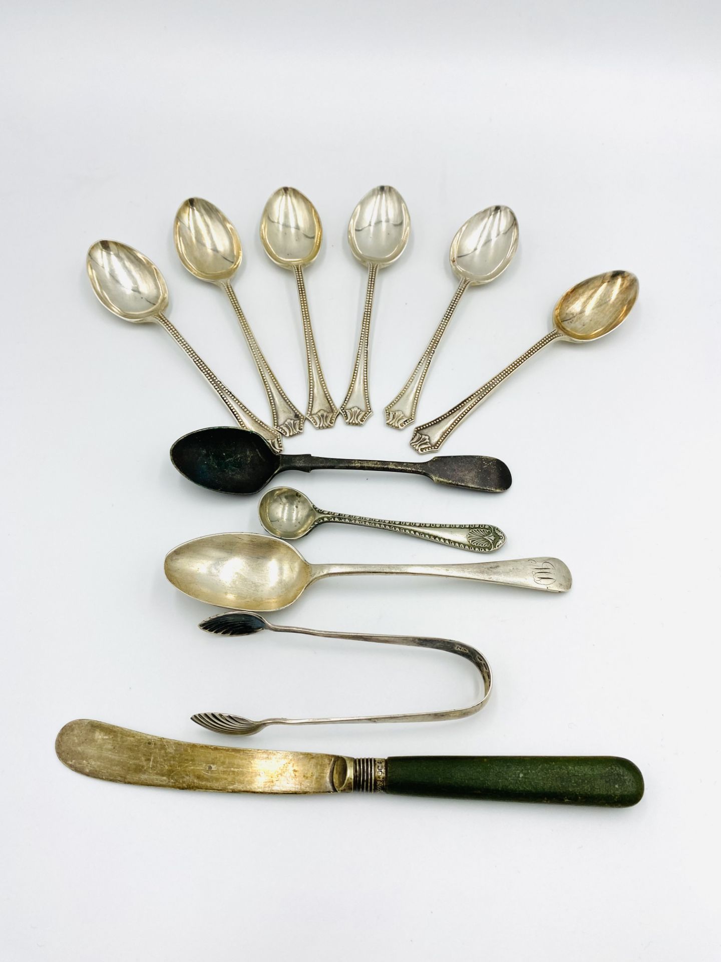 Six silver teaspoons; two other silver tea spoons and a pair of silver sugar tongs