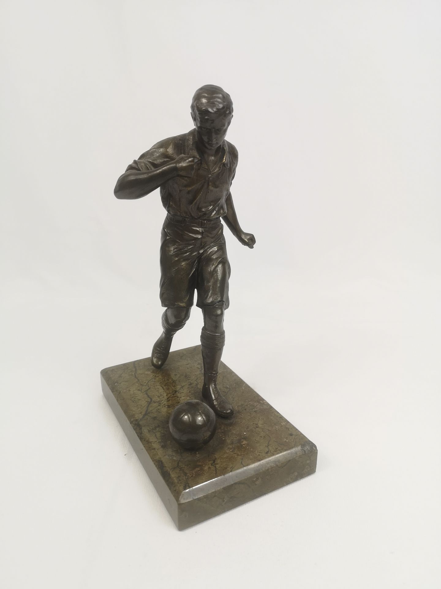 Bronzed figurine of a footballer