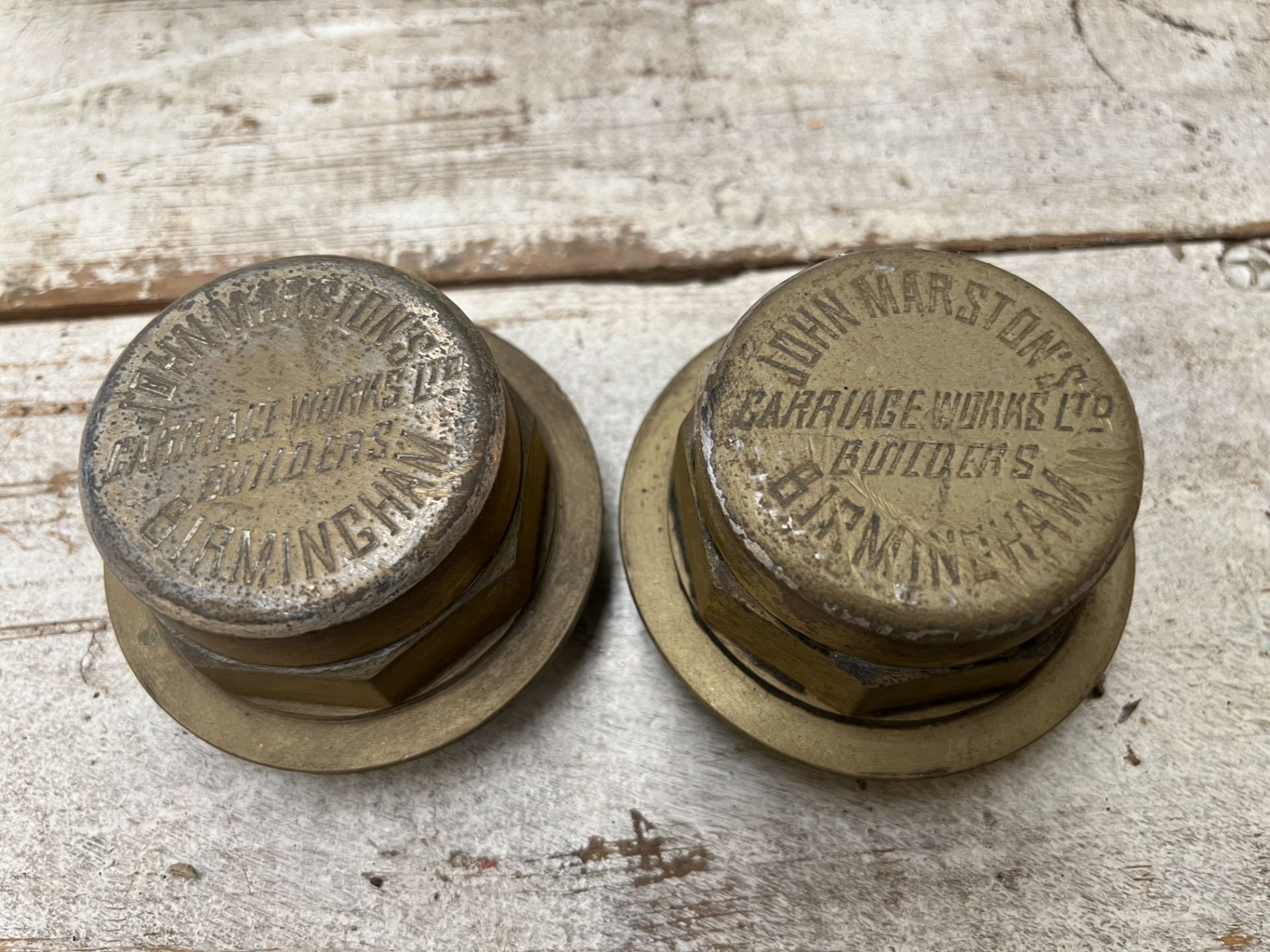 A pair of brass hub caps engraved John Marston's, Birmingham