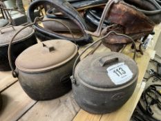 Two cast iron lidded cooking pots