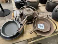 Five griddle pans, a saucepan, and 3 frying pans